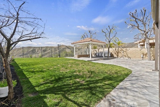 view of yard featuring a gazebo, a patio area, and a fenced backyard