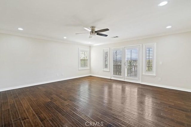 empty room featuring ceiling fan, baseboards, dark wood-style flooring, and ornamental molding