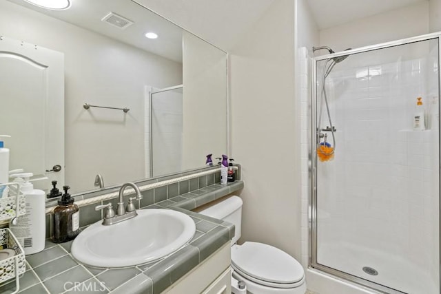 full bath featuring toilet, a stall shower, visible vents, and vanity