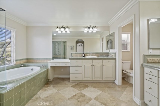 bathroom with a garden tub, toilet, ornamental molding, a stall shower, and vanity