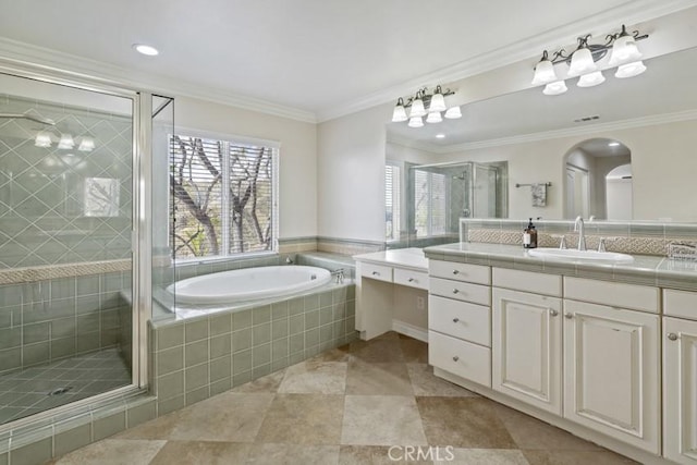 full bath with tile patterned flooring, vanity, ornamental molding, a bath, and a stall shower