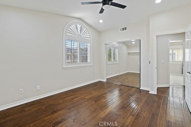 unfurnished bedroom with multiple windows, wood-type flooring, and visible vents