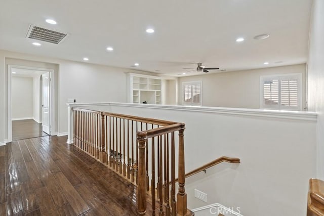 hallway featuring visible vents, baseboards, hardwood / wood-style flooring, an upstairs landing, and recessed lighting