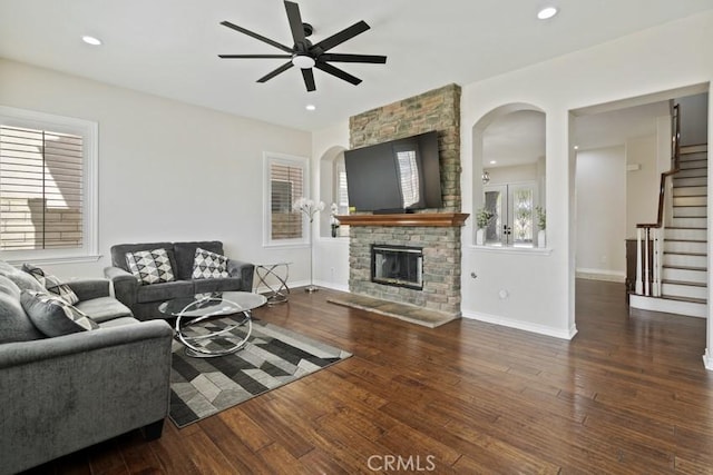 living room with stairs, a fireplace, hardwood / wood-style flooring, and recessed lighting