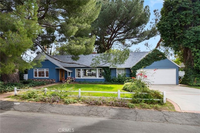 ranch-style house featuring a fenced front yard, a front yard, concrete driveway, and a garage