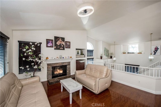 living room with lofted ceiling, a fireplace, wood finished floors, and baseboards