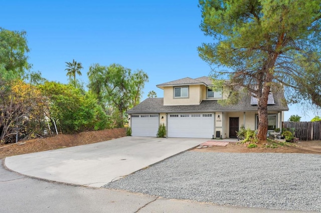 view of front facade featuring solar panels, a porch, stucco siding, concrete driveway, and fence