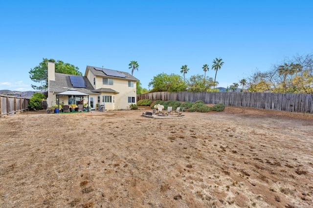 view of yard with an outdoor fire pit, a patio area, a fenced backyard, and a gazebo