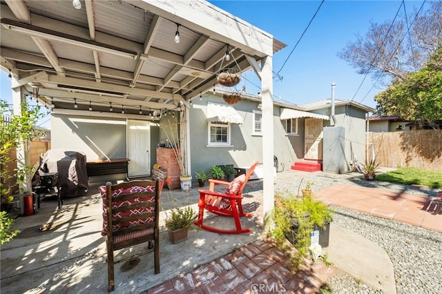 view of patio featuring entry steps and fence