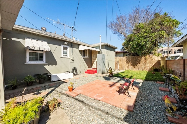 back of property featuring entry steps, a patio, fence, and stucco siding