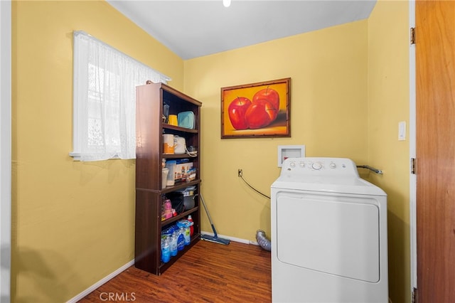 clothes washing area featuring laundry area, baseboards, washer / clothes dryer, and wood finished floors