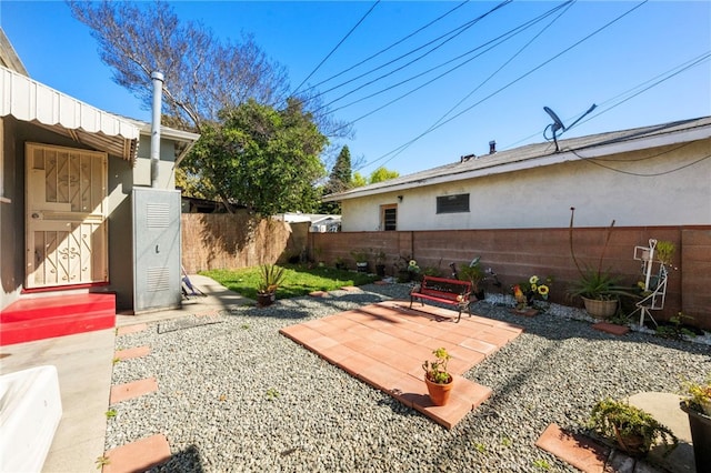 view of yard featuring a patio area and a fenced backyard