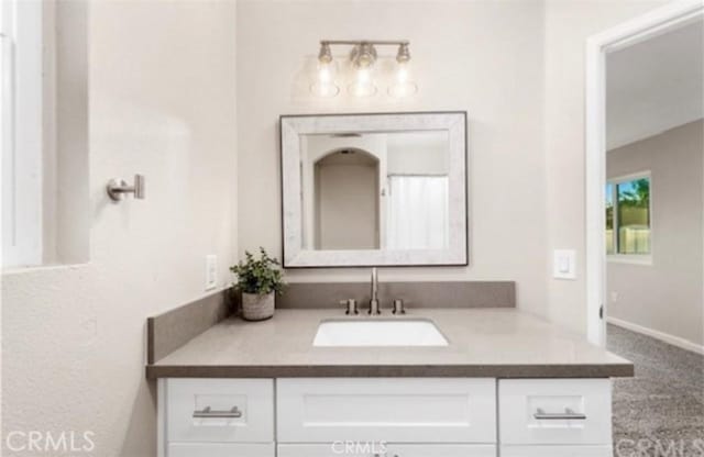 bathroom with vanity and baseboards