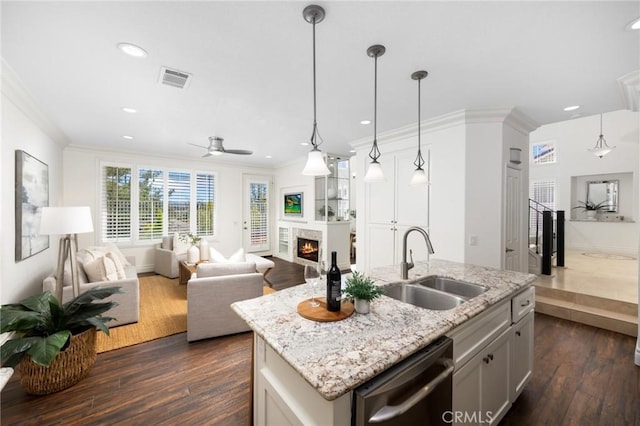 kitchen with dishwashing machine, dark wood-style flooring, a warm lit fireplace, a sink, and crown molding