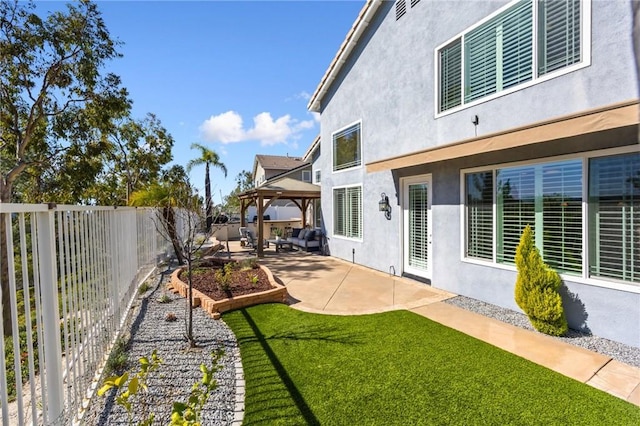 view of yard featuring a gazebo, a patio, and a fenced backyard