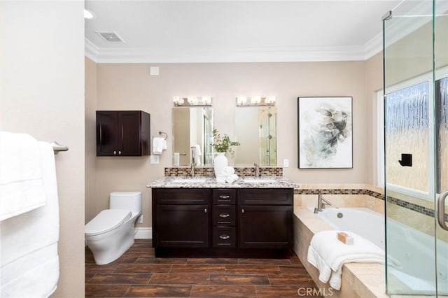 full bath with visible vents, toilet, crown molding, double vanity, and a bath