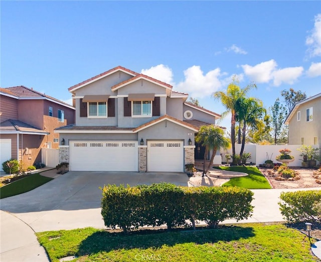 view of front of house featuring stucco siding, driveway, stone siding, fence, and a garage