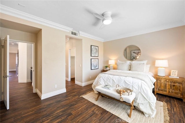 bedroom with dark wood-style floors, visible vents, baseboards, and ornamental molding