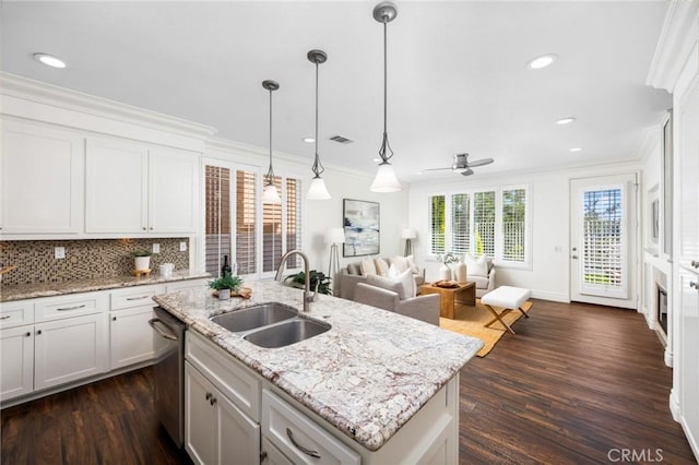 kitchen with dishwasher, crown molding, visible vents, and a sink