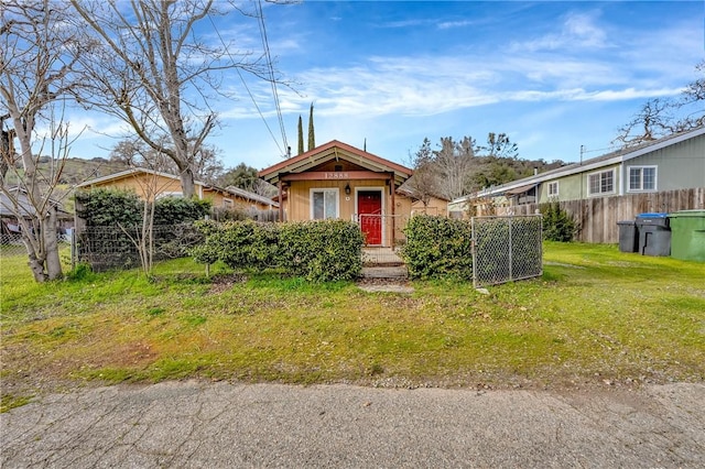 view of front of property with fence and a front lawn