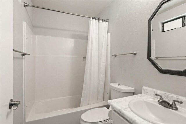 full bathroom with shower / tub combo with curtain, vanity, and toilet