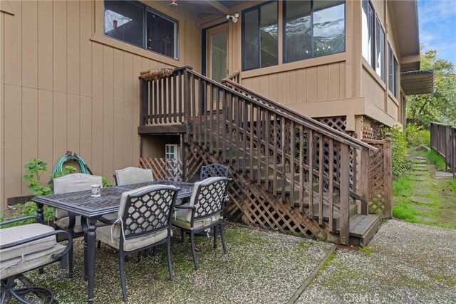 view of patio / terrace featuring outdoor dining area and stairway