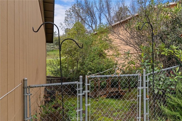 view of yard with fence and a gate