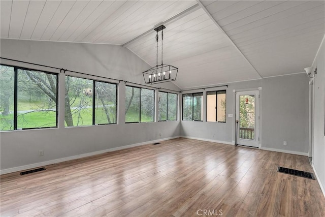 unfurnished sunroom featuring lofted ceiling, visible vents, and a notable chandelier