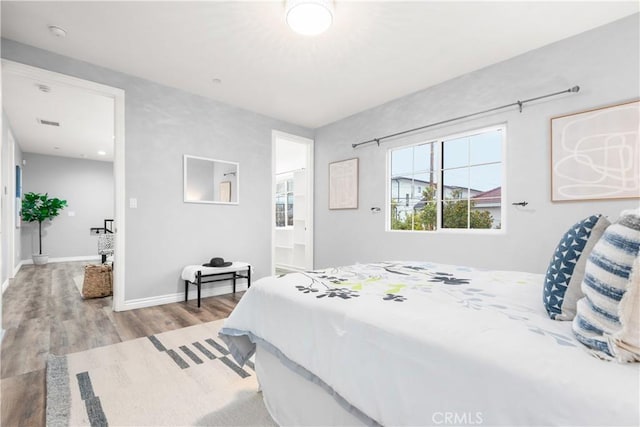 bedroom featuring baseboards and wood finished floors