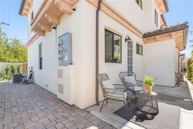 view of patio / terrace featuring central AC unit and fence