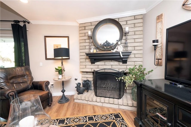 living room with ornamental molding, a fireplace, wood finished floors, and baseboards