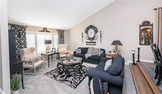 living room featuring high vaulted ceiling, baseboards, and wood finished floors