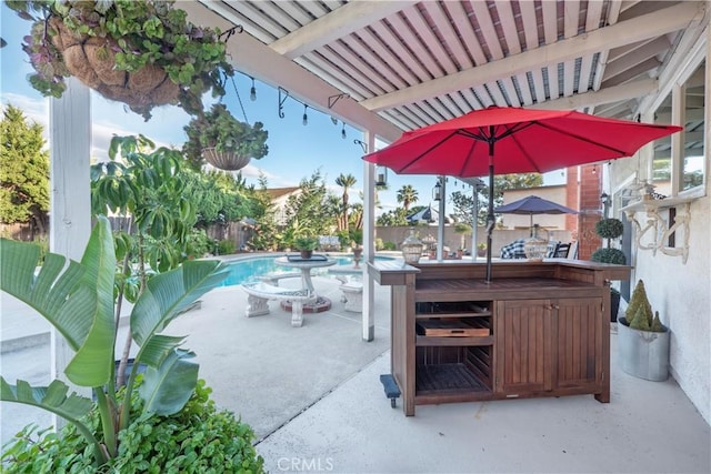 view of patio with a fenced in pool, a fenced backyard, and outdoor dry bar