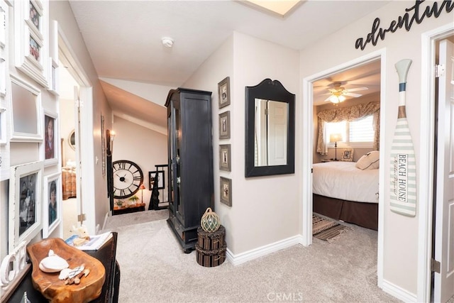 hallway with carpet flooring and baseboards