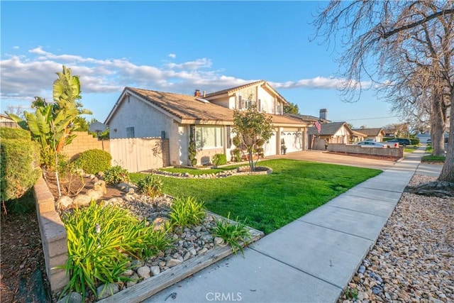 exterior space with concrete driveway, a lawn, an attached garage, fence, and stucco siding