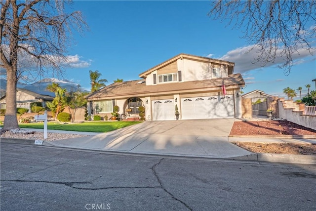 view of front of home featuring a garage, fence, driveway, stucco siding, and a front lawn