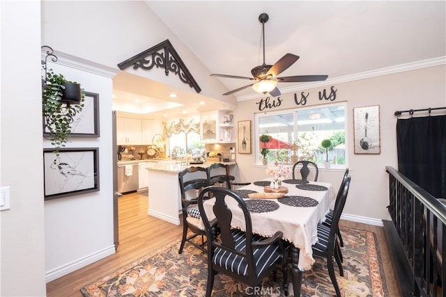 dining room with ornamental molding, wood finished floors, a ceiling fan, and baseboards