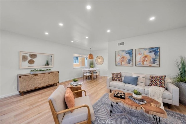 living area featuring recessed lighting, light wood-style flooring, visible vents, and baseboards