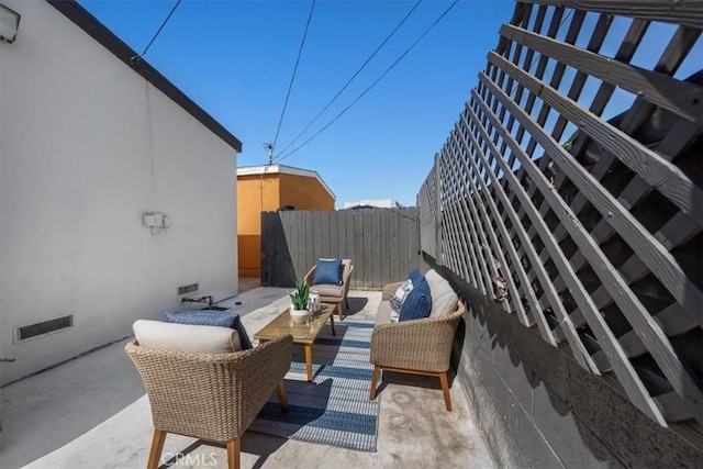 view of patio / terrace featuring fence and an outdoor living space