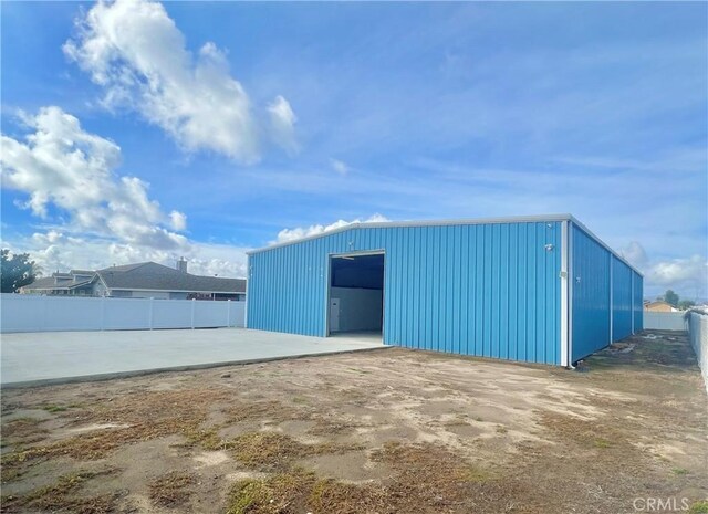 view of outdoor structure with an outbuilding and fence