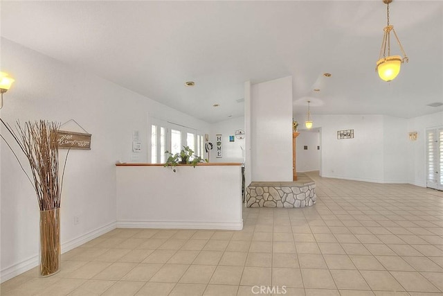 interior space featuring plenty of natural light, light tile patterned flooring, and baseboards