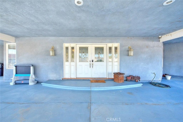 entrance to property with french doors and stucco siding