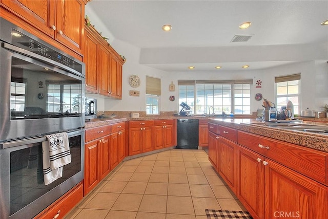 kitchen featuring recessed lighting, visible vents, appliances with stainless steel finishes, brown cabinetry, and light tile patterned flooring