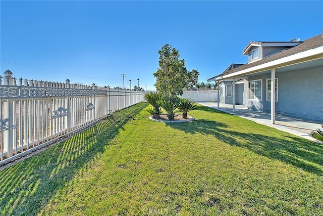 view of yard with a patio area and a fenced backyard