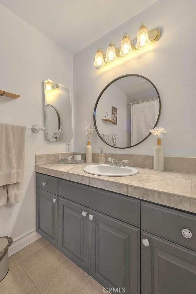 full bath with tile patterned floors and vanity