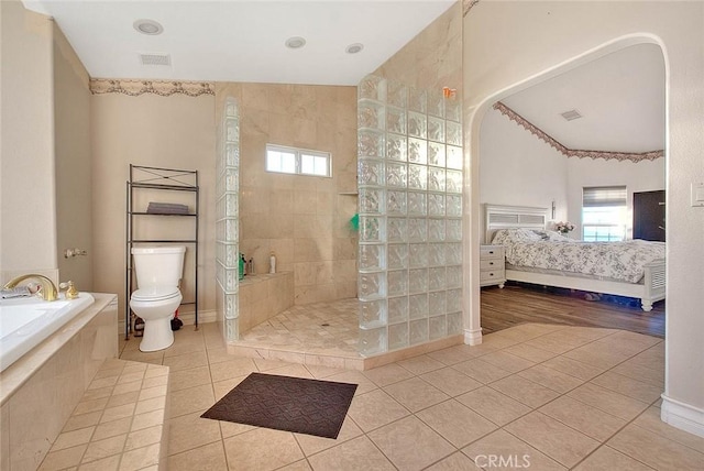 full bath with tile patterned floors, a healthy amount of sunlight, walk in shower, and ensuite bathroom