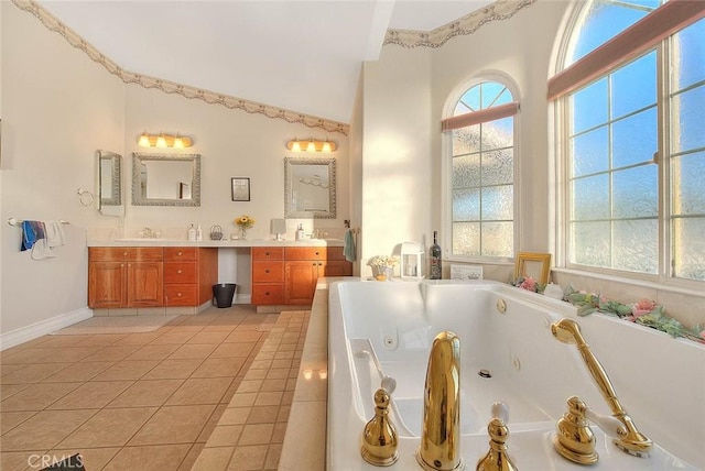 full bathroom with double vanity, lofted ceiling, a sink, a jetted tub, and tile patterned floors