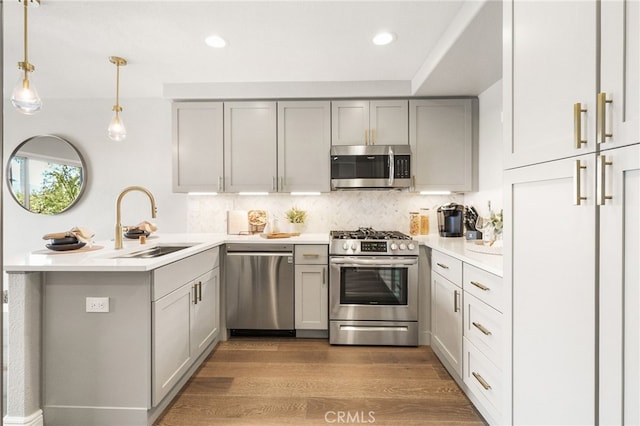 29416 Port Royal Way, Laguna Niguel, CA 92677 - kitchen featuring appliances with stainless steel finishes, gray cabinets, a sink, a peninsula, and decorative backsplash