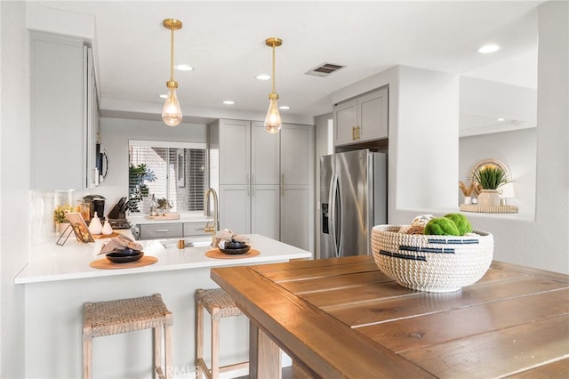 29416 Port Royal Way, Laguna Niguel, CA 92677 - kitchen with stainless steel appliances, gray cabinets, a peninsula, decorative light fixtures, and light countertops
