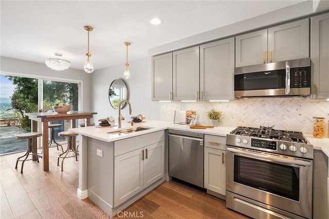 29416 Port Royal Way, Laguna Niguel, CA 92677 - kitchen with appliances with stainless steel finishes, gray cabinetry, a sink, a peninsula, and recessed lighting